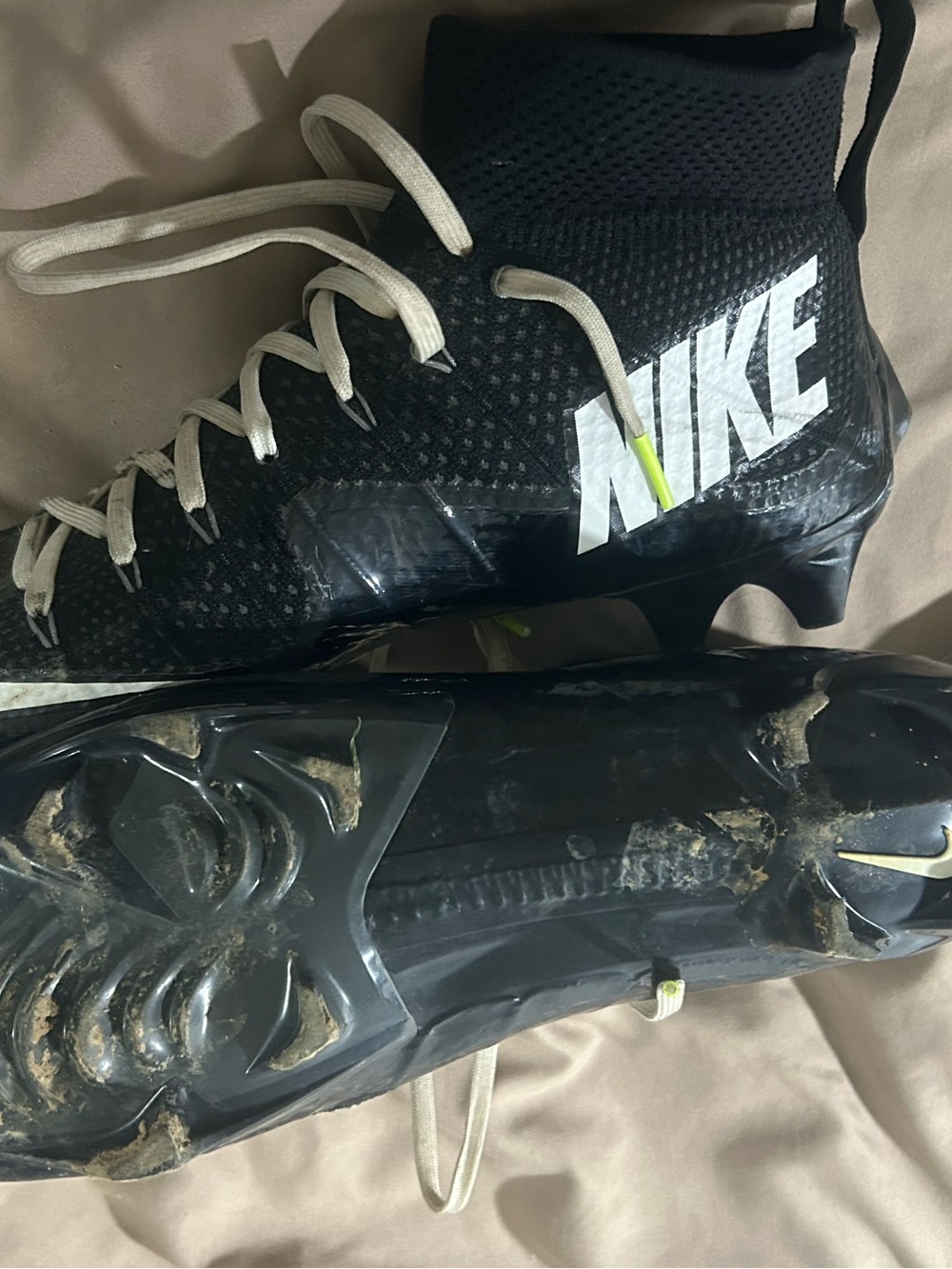 Nike Black and White High-Top Athletic Cleats with Neon Yellow Accent